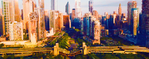 Image shows an aerial shot of the city of Chicago in the ruins of the Divergent series; this shot serves as the establishing shot for the novel's setting. Some of the buildings are in tact while others appear to be barely holding together. The river that once ran through the city, the Chicago River, has long since dried up; in the years that followed, lush vegetation has taken over the area.